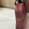 Genuine red and black leather laptop bag with zip-around opening and contrast trim