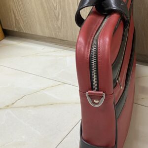Genuine red and black leather laptop bag with zip-around opening and contrast trim
