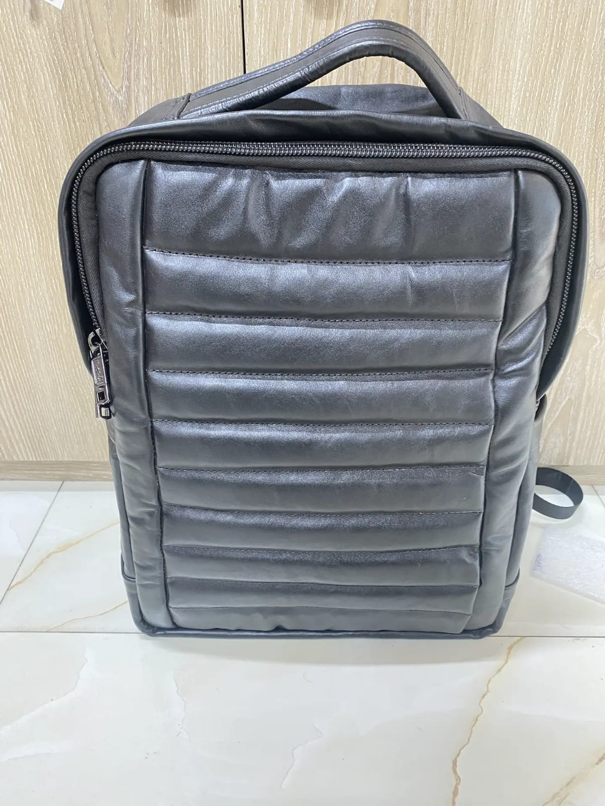 Genuine black quilted leather backpack with padded mesh straps