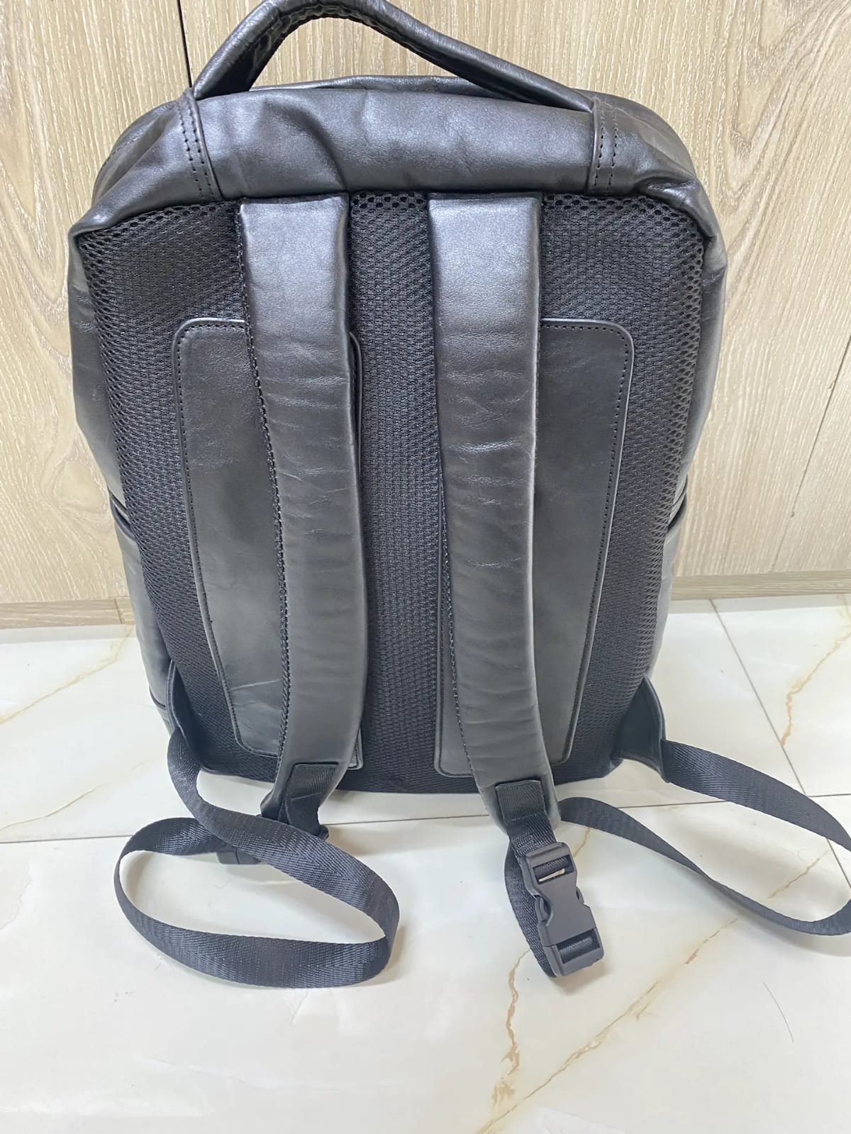 Genuine black quilted leather backpack with padded mesh straps